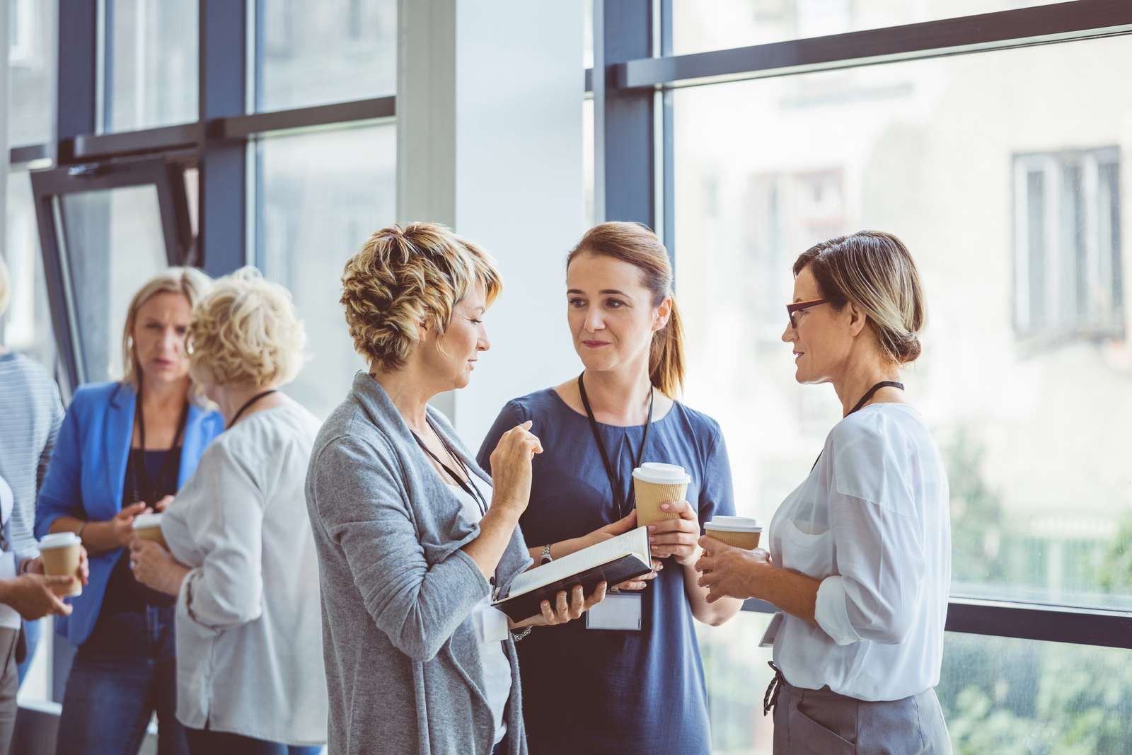 Group of women talking during coffee break at convention center. Break during a women seminar.